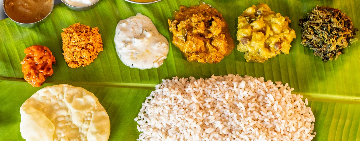 Kerala meals on a banana leaf: rice, pappadam, curries, thoran and pickle